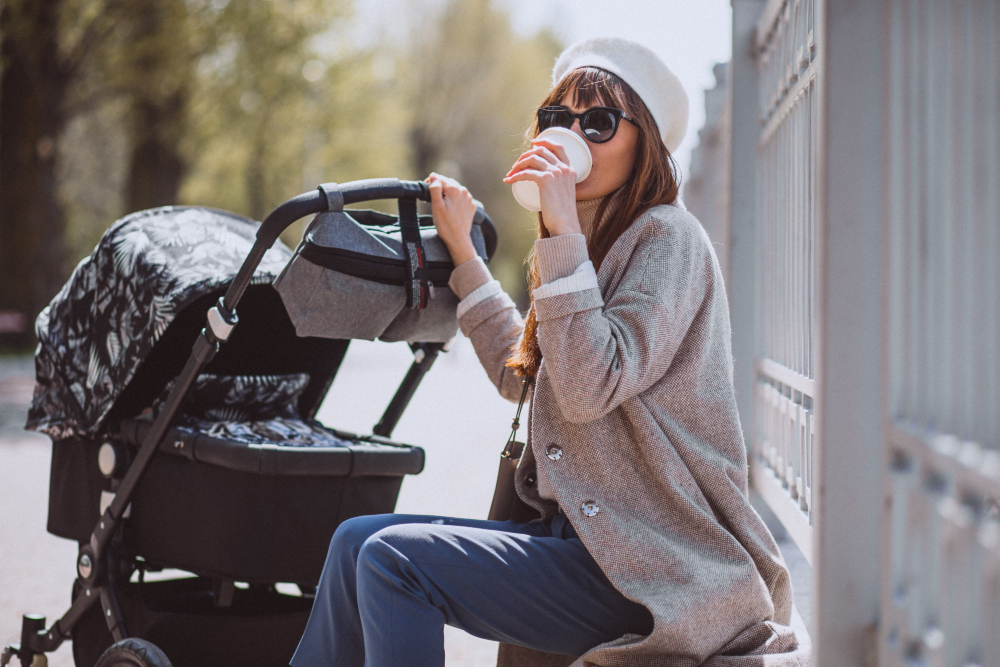American parent with stroller organizer on city street